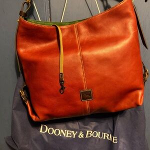 Dooney & Bourke smooth leather handbag, rust/brick color.